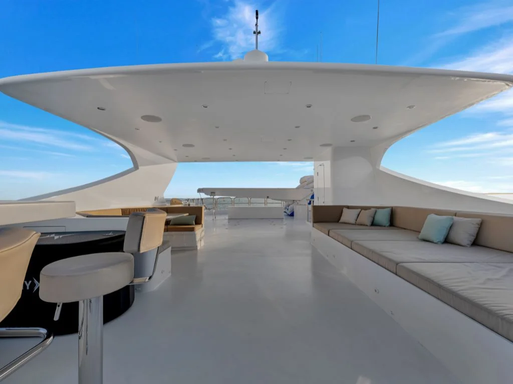 Main deck of 166 Trinity yacht with outdoor seating and dining area