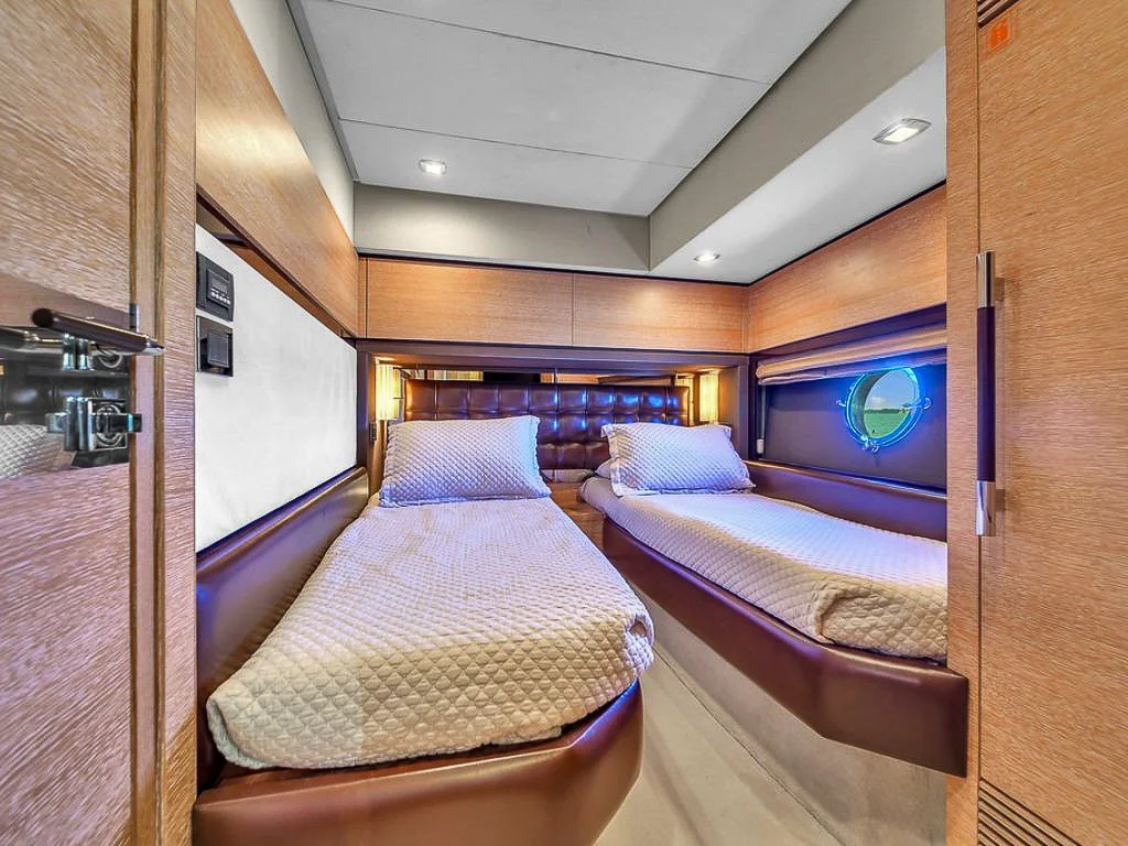 Master cabin on the 70 Azimut V with warm lighting and large windows