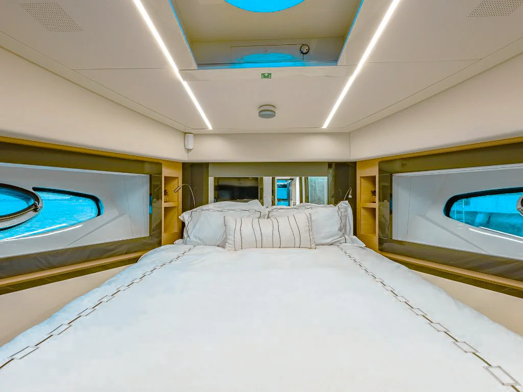 Master cabin on the 70 Pershing yacht with a large bed and soft furnishings