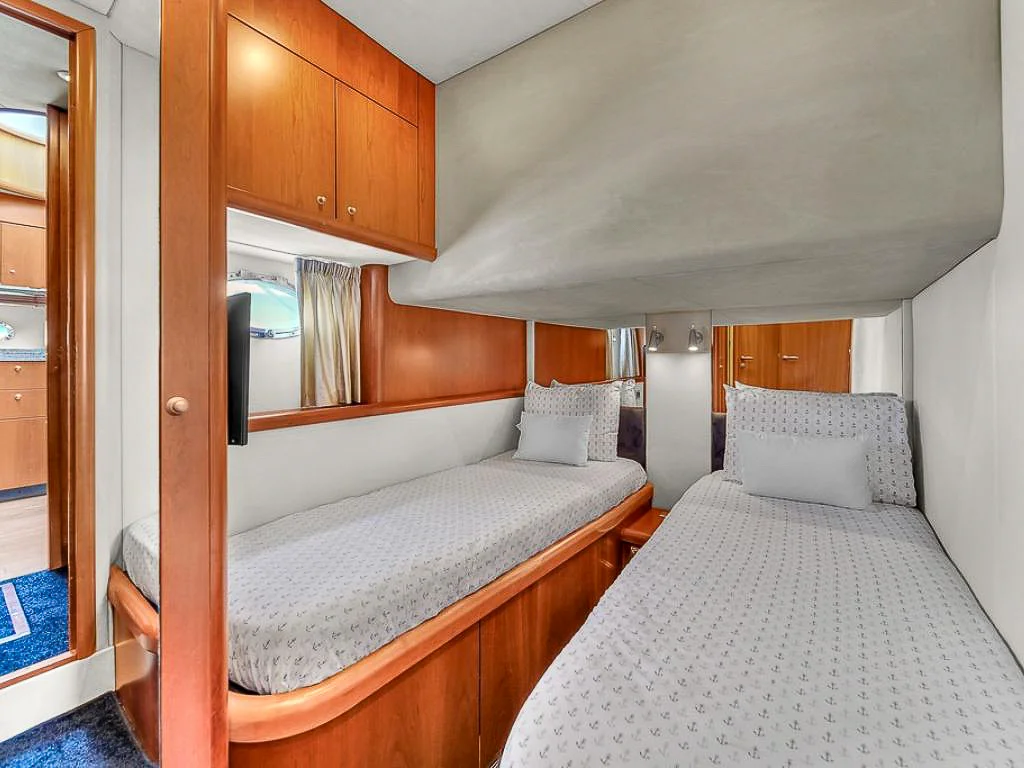 Interior view of a luxurious master cabin bedroom on the 72 Sunseeker II