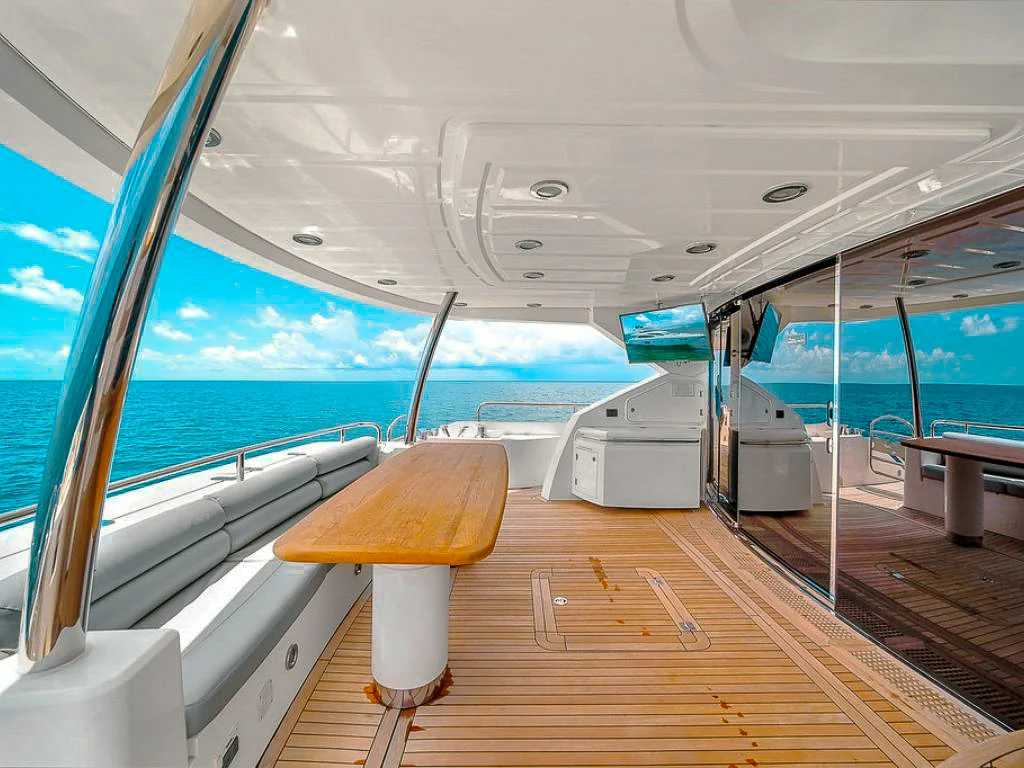 Back deck of the 80 Sunseeker II with dining table and chairs
