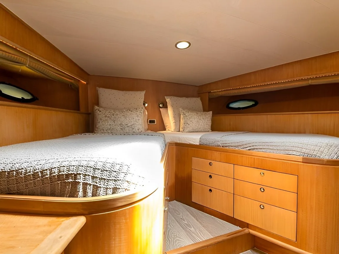 Another yacht cabin with a cozy bed and wooden features