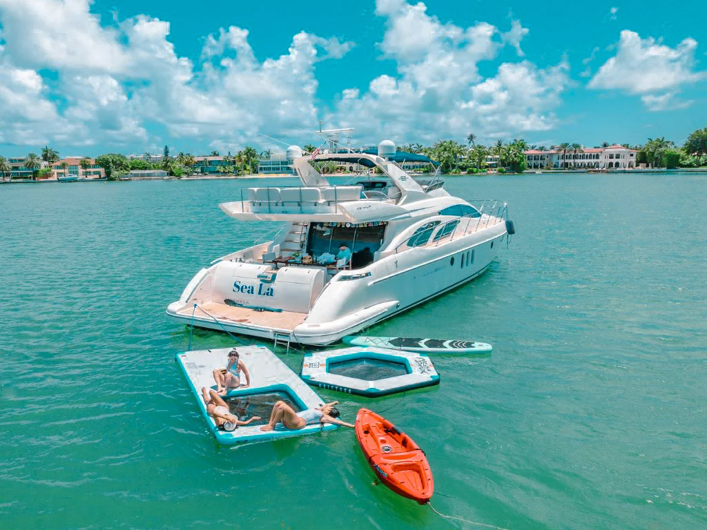 Luxurious 84 Azimut Flybridge yacht navigating clear turquoise waters in the Bahamas