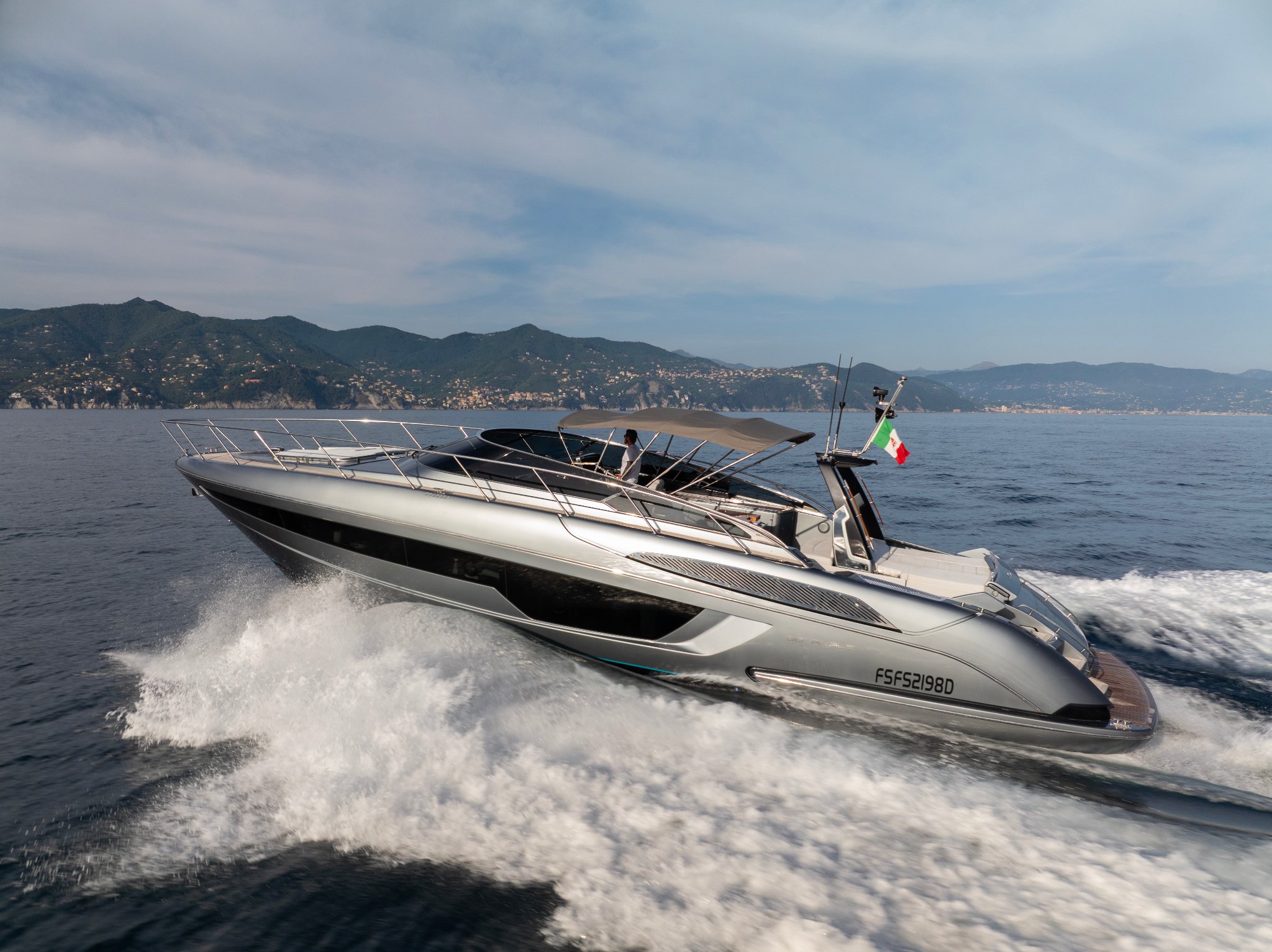 56ft Riva Rivale yacht available for charter in La Spezia, Italy with guests enjoying the view.