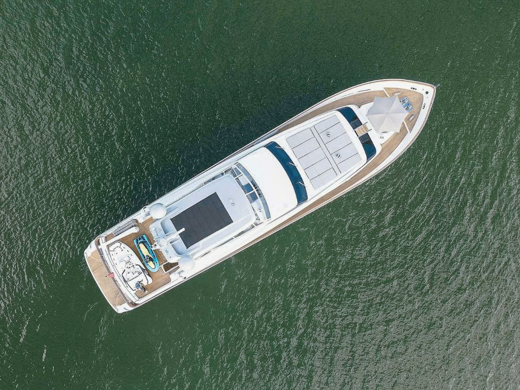 A guest relaxing on a sunpad on the deck of the 108 San Lorenzo yacht