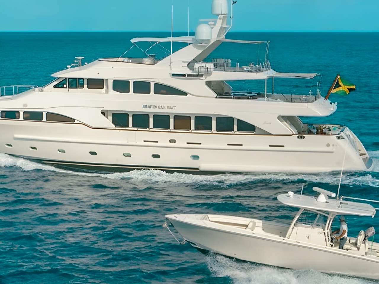 Luxurious 115ft Benetti yacht sailing in the clear blue waters of The Bahamas