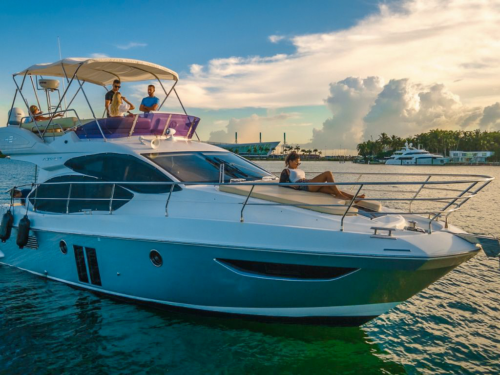 Newly listed 42ft Azimut Fly yacht cruising in Miami waters, perfect for charter.