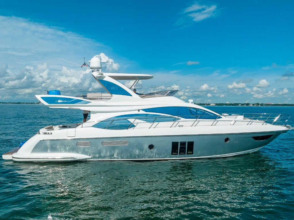 Luxury 60ft Azimut yacht S II docked in Miami with guests ready to embark on a charter.