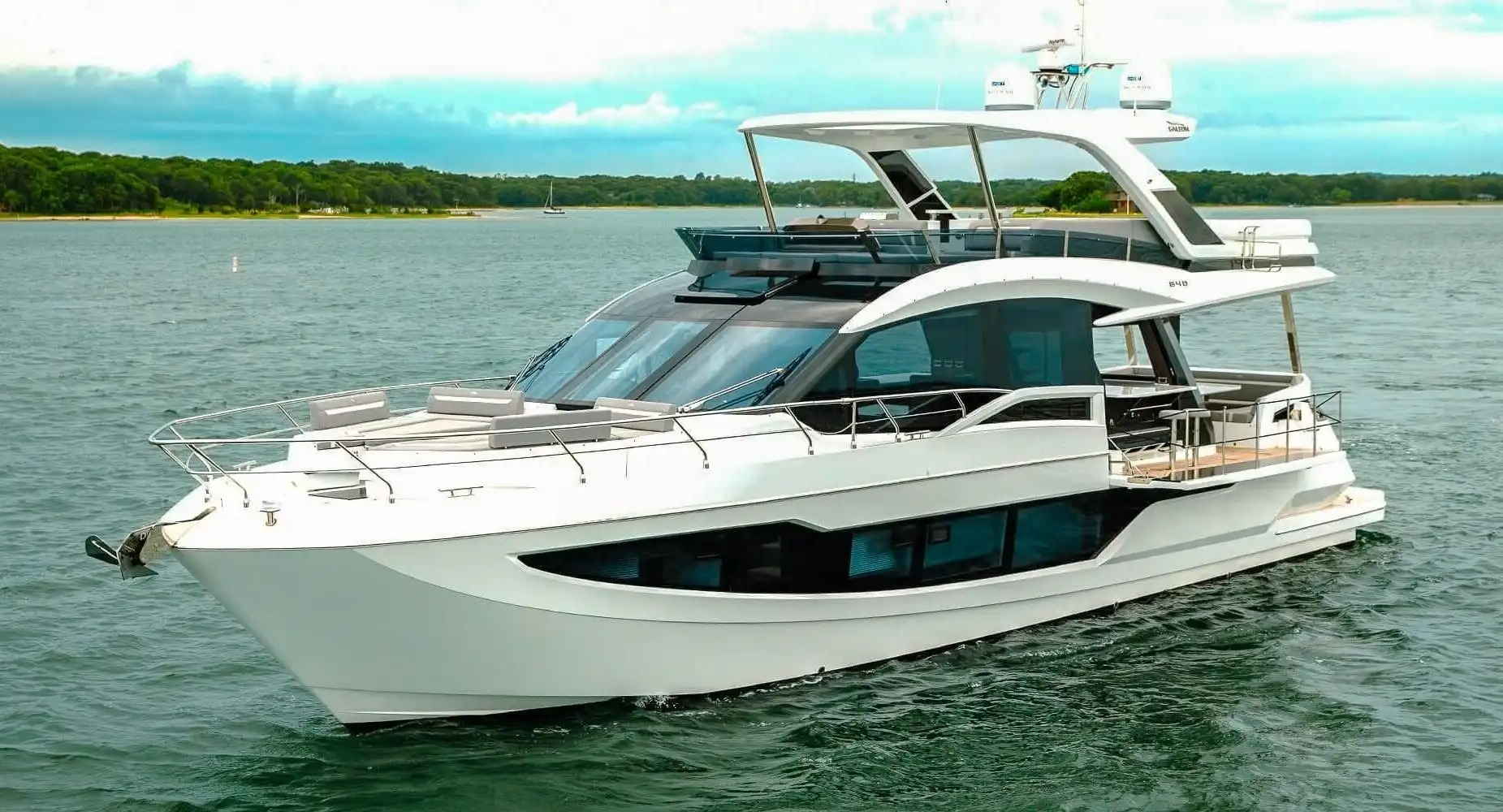 Exterior view of the 68 Galeon yacht in Miami with a beach club