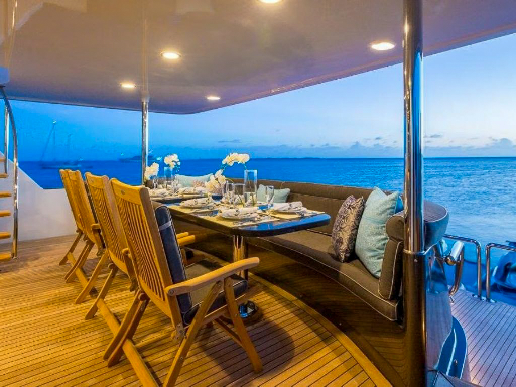 Aft deck of the 116 Crescent yacht with dining area