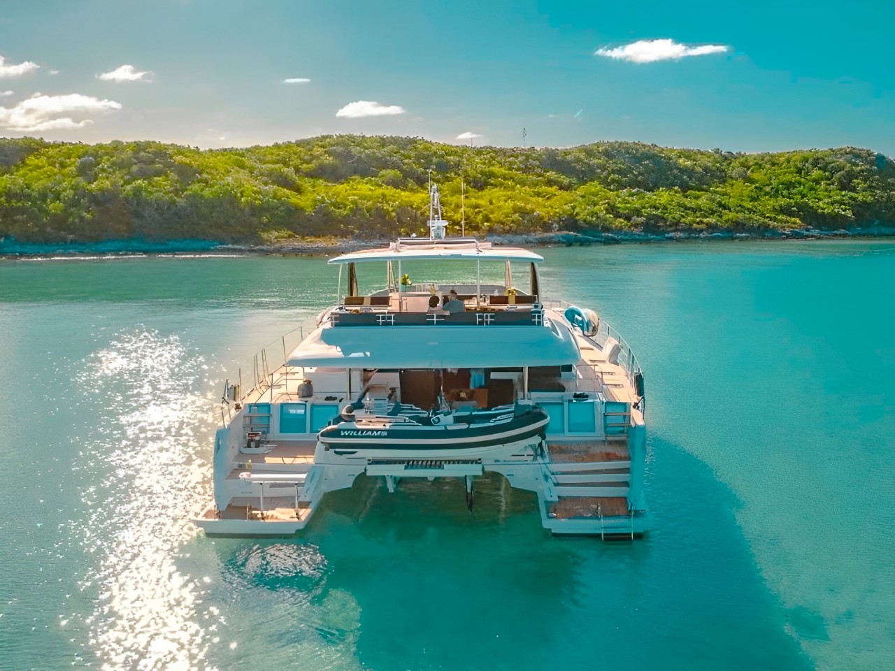 Guests enjoying water slide from 64 Lagoon II yacht
