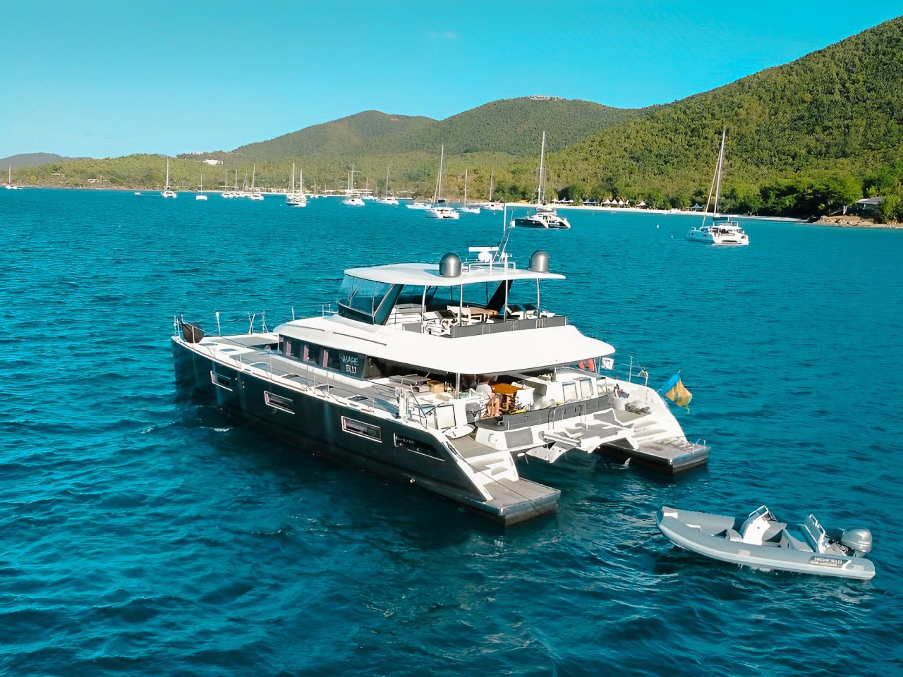 Luxury 64ft Lagoon catamaran yacht sailing in the clear turquoise waters of the Bahamas.
