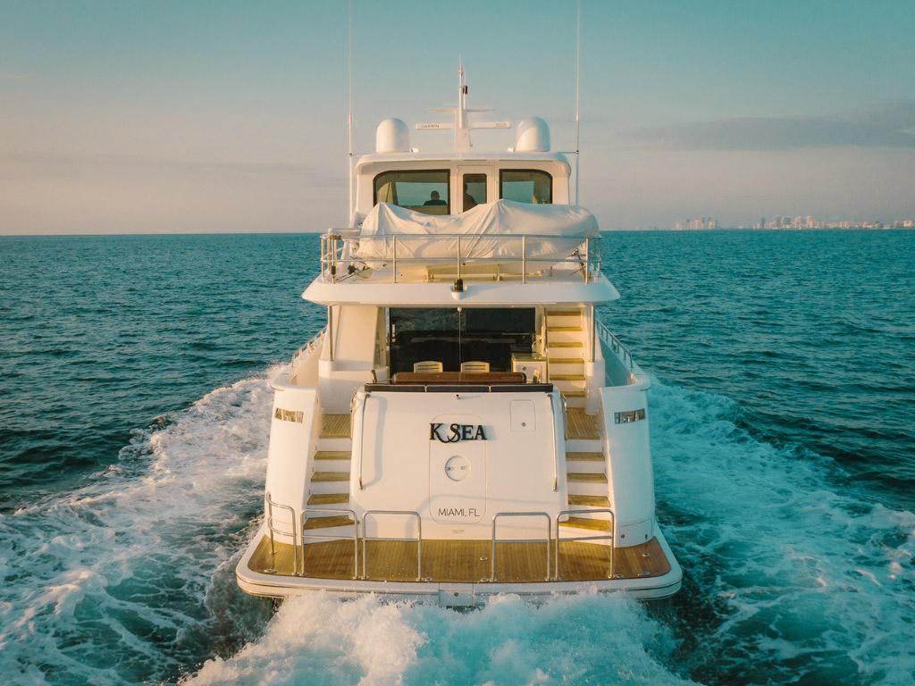 Guests relaxing on the bow of the 75 Hatteras yacht