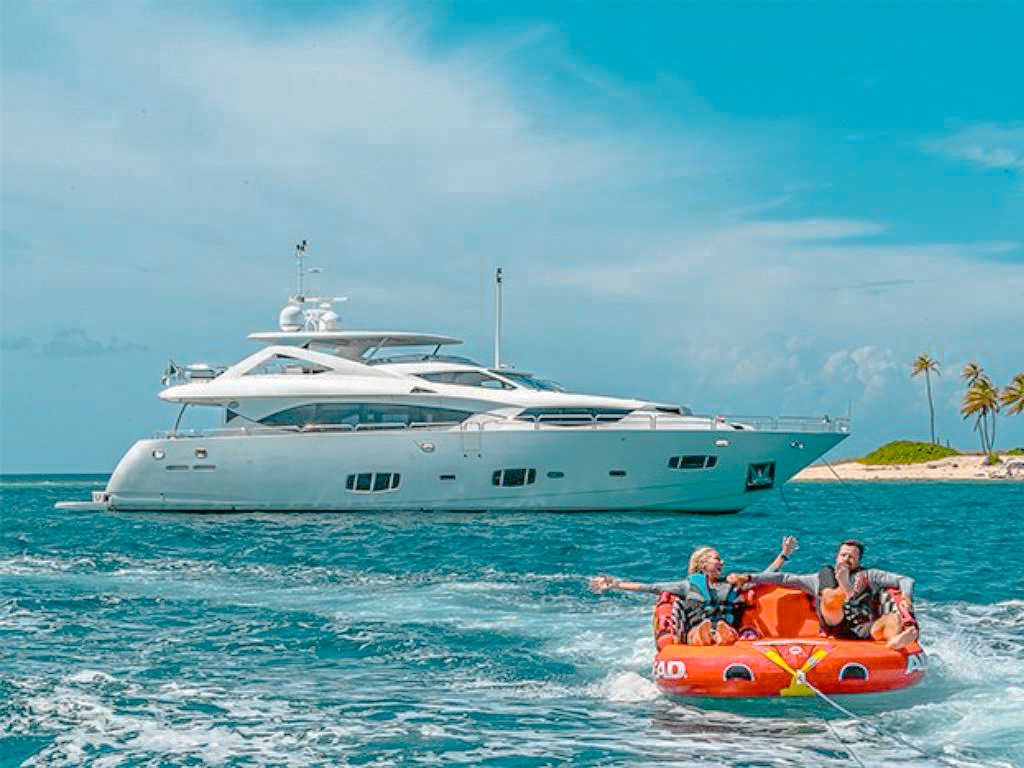Side exterior view of the 98 Sunseeker yacht with guests on deck