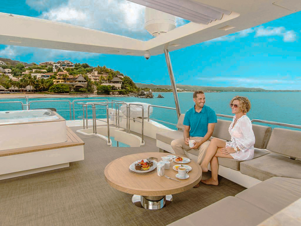 People enjoying the Jacuzzi on the deck of the 105 Azimut