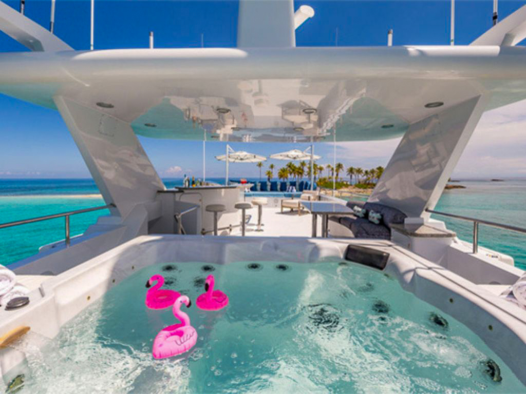 Open deck area on 146 Heesen II yacht with sun loungers and ocean view