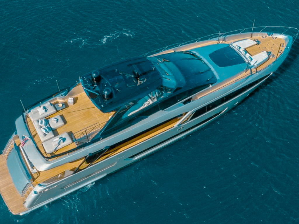 Side view of the 94 Riva yacht cruising through blue water
