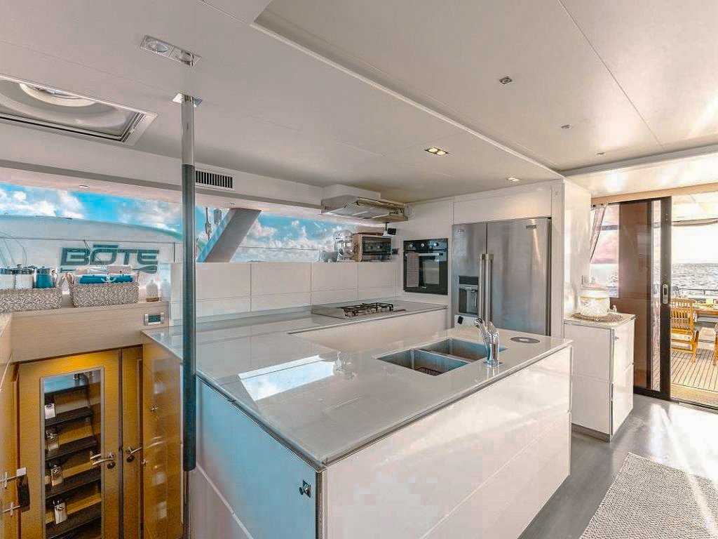 Paddleboarder enjoying the calm Caribbean waters next to 70 Fountaine Pajot II