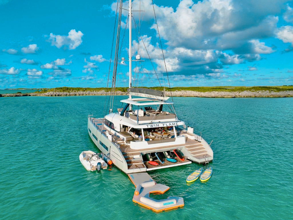 Side view of 78 Lagoon III yacht at anchor in clear Caribbean waters