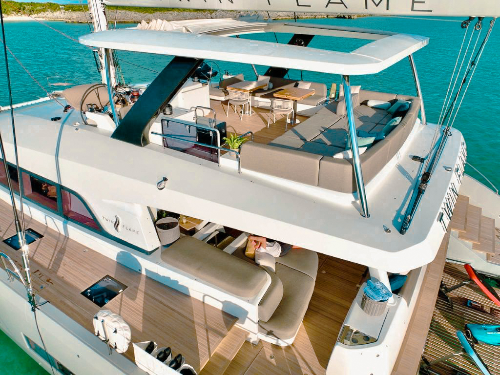 Aerial view of 78 Lagoon III yacht cruising in turquoise waters near a tropical island