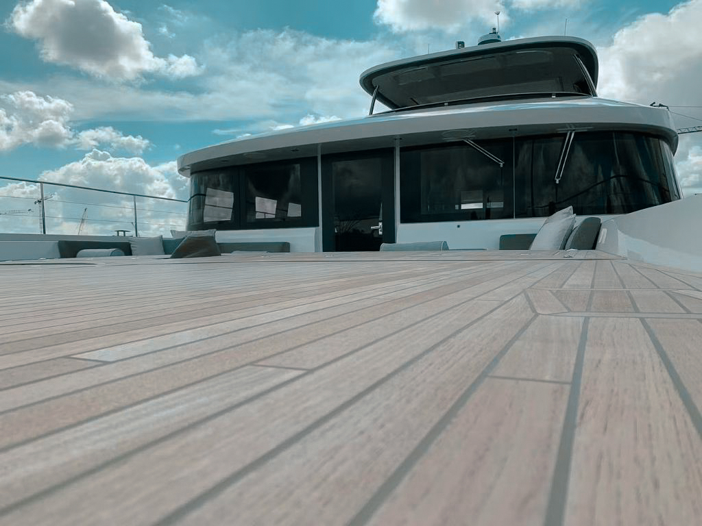 Guests enjoying the deck of the 78 Lagoon yacht with a water slide