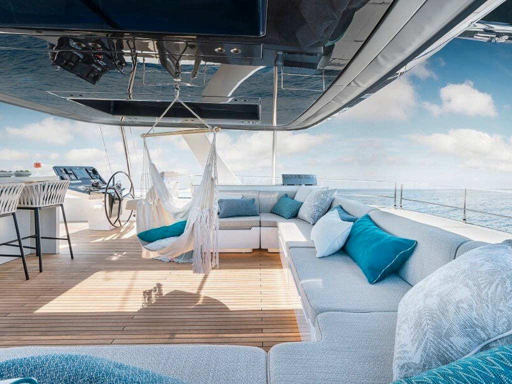 80 Sunreef VI yacht with guests enjoying a water slide