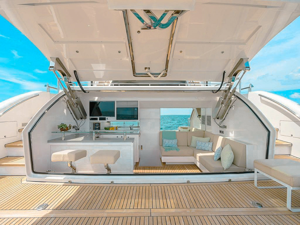 A couple enjoying the front deck of 90 Horizon yacht