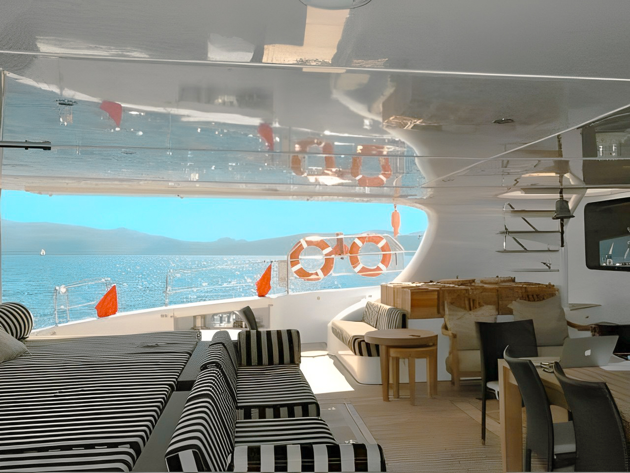 People enjoying activities on the water next to the 102 Sunreef yacht
