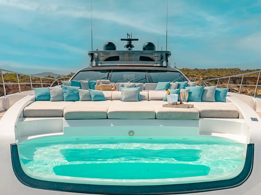 Spacious aft deck of the 110 Mangusta, showing water toys and ample seating
