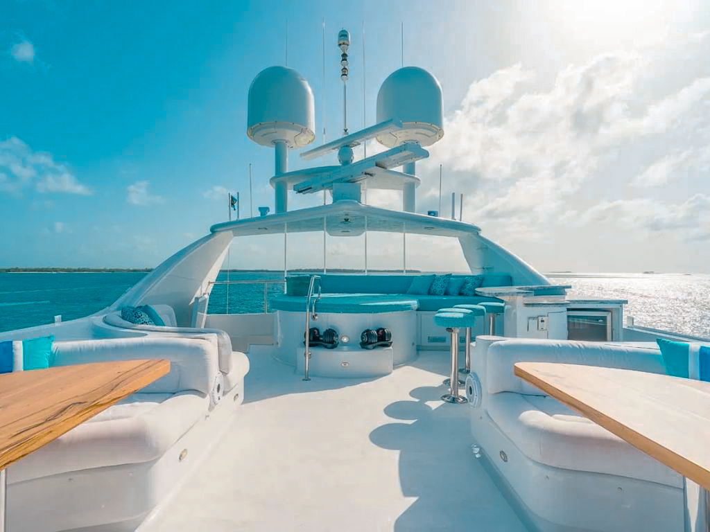 View of yacht's spacious back deck with dining area on the 132 Sunseeker