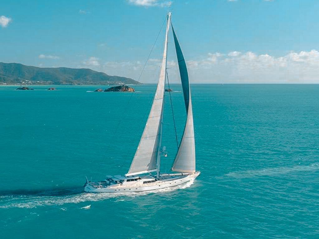 Guests relaxing on the deck of 155 Royal Huisman at sunset