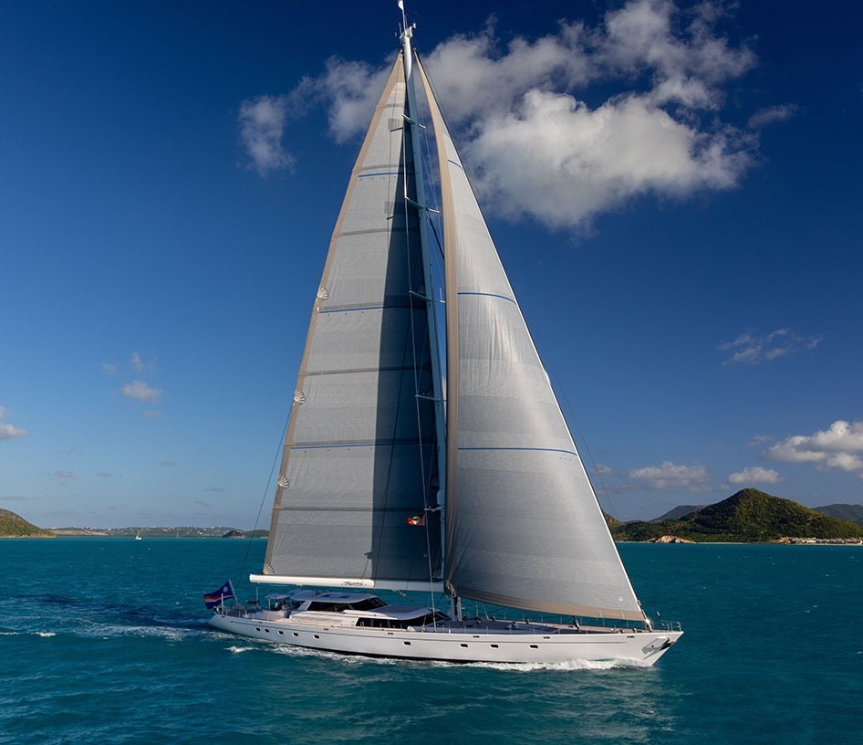 155 Royal Huisman yacht anchored near a beautiful island