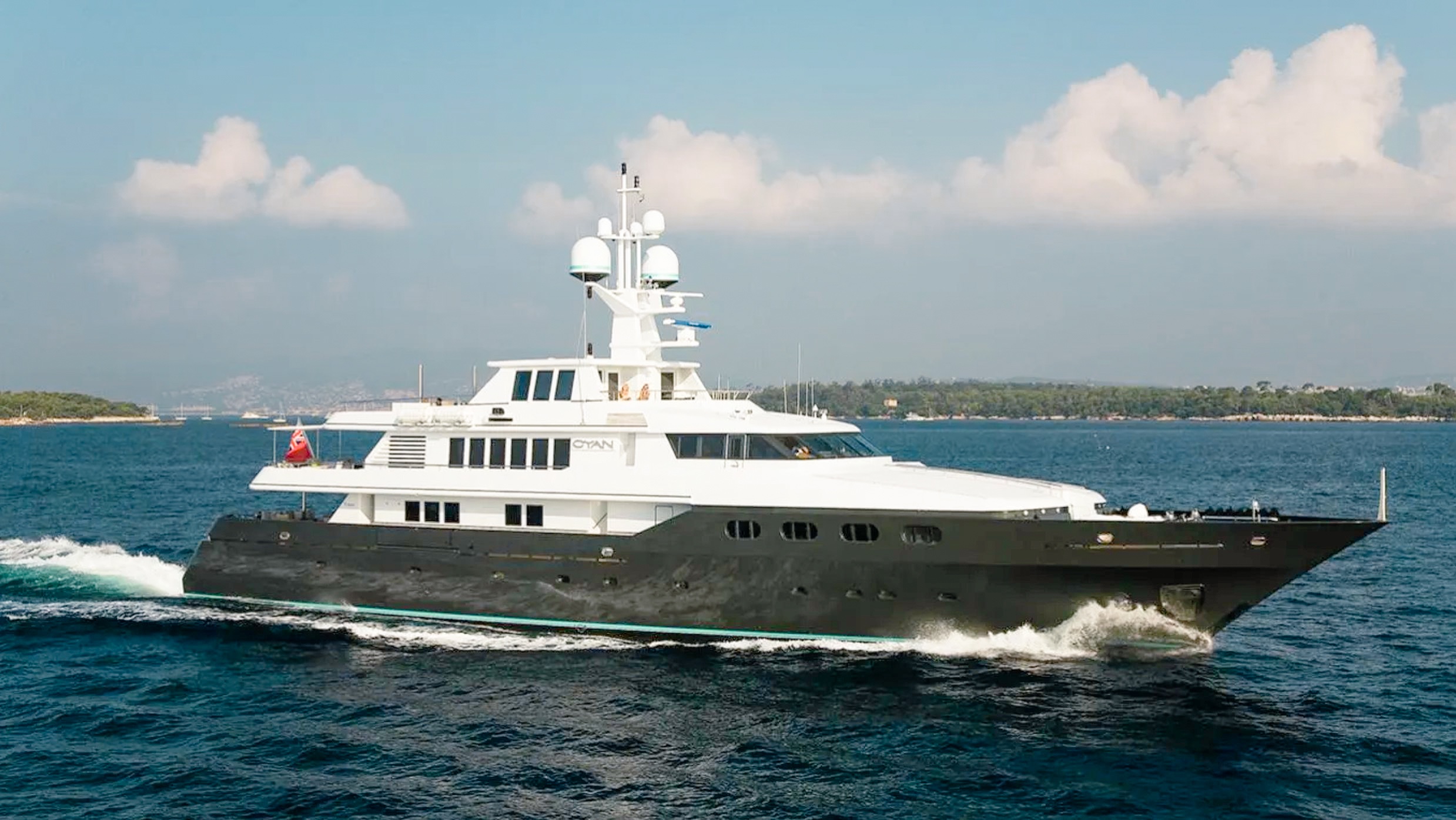 Luxurious 172ft Codecasa yacht cruising in clear Caribbean waters with guests.
