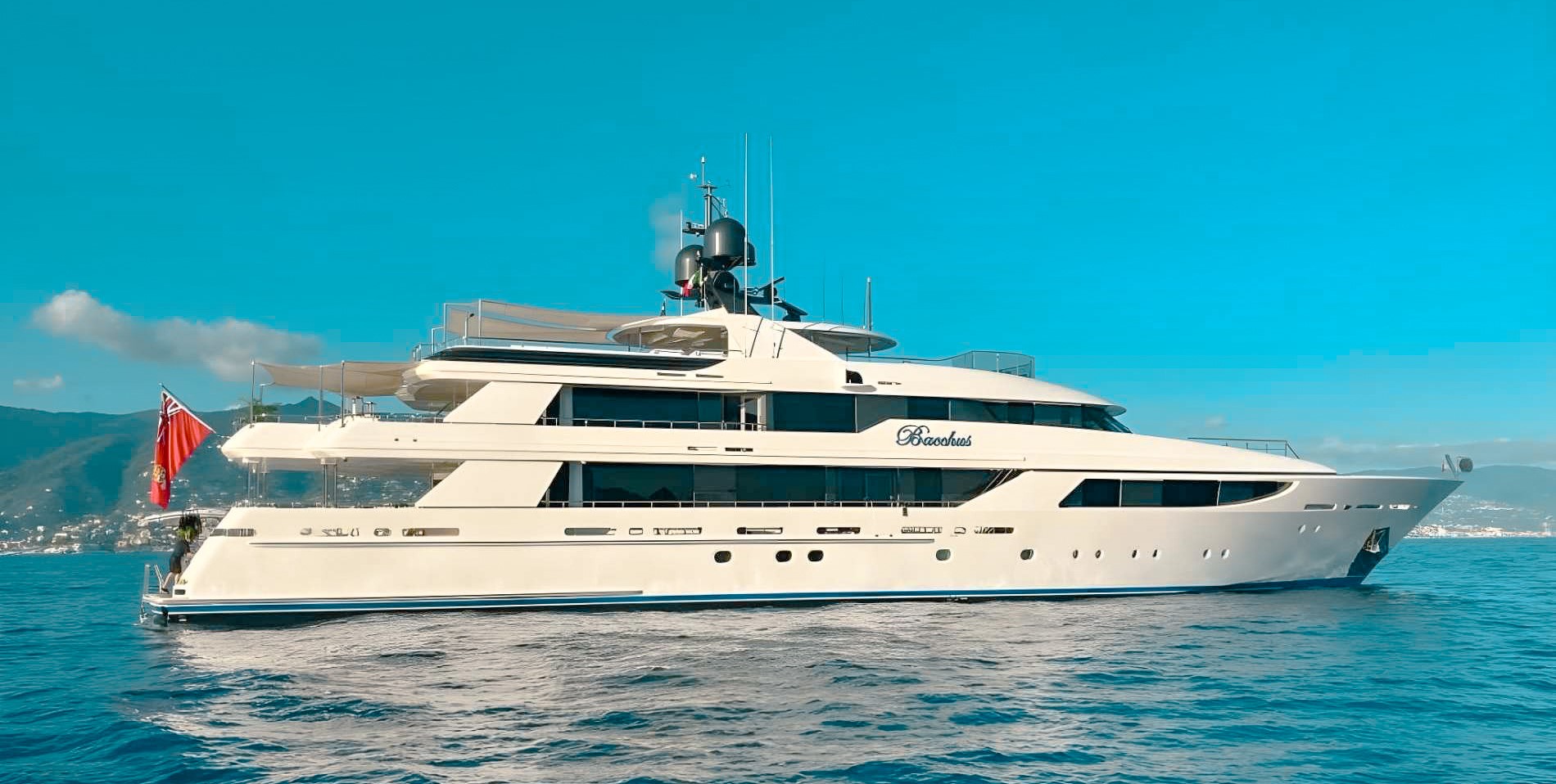 164ft Westport yacht cruising through clear blue Caribbean waters during a luxury charter trip.