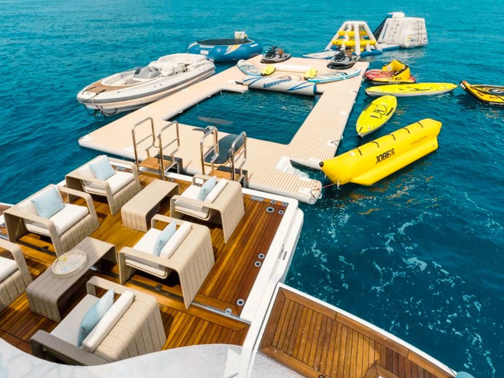 The back deck of the 208 Benetti II yacht with comfortable seating and a view of the ocean.