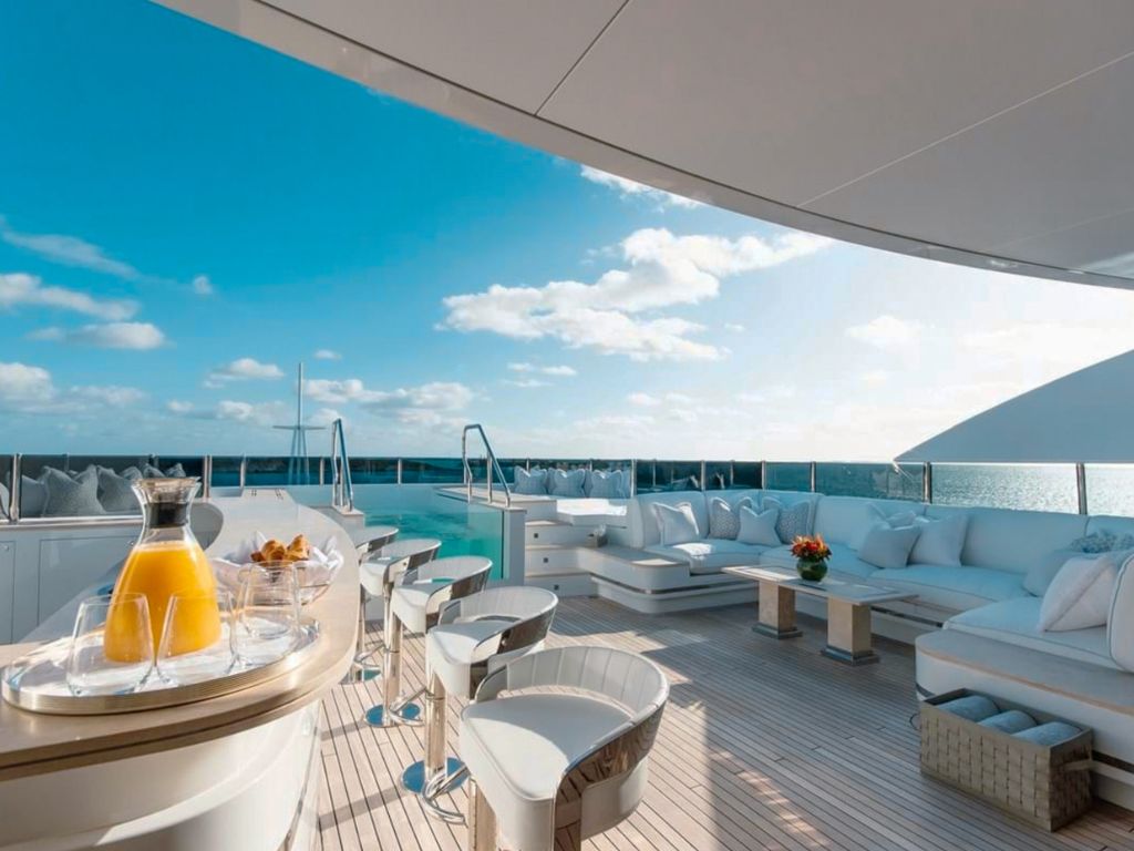Expansive deck of 207 Sunrise yacht with lounging areas and dining setup
