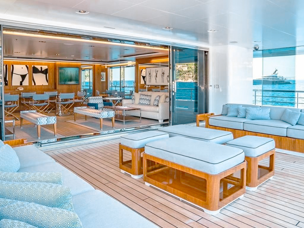 A group enjoying a meal on the outdoor deck of the 240 Admiral yacht
