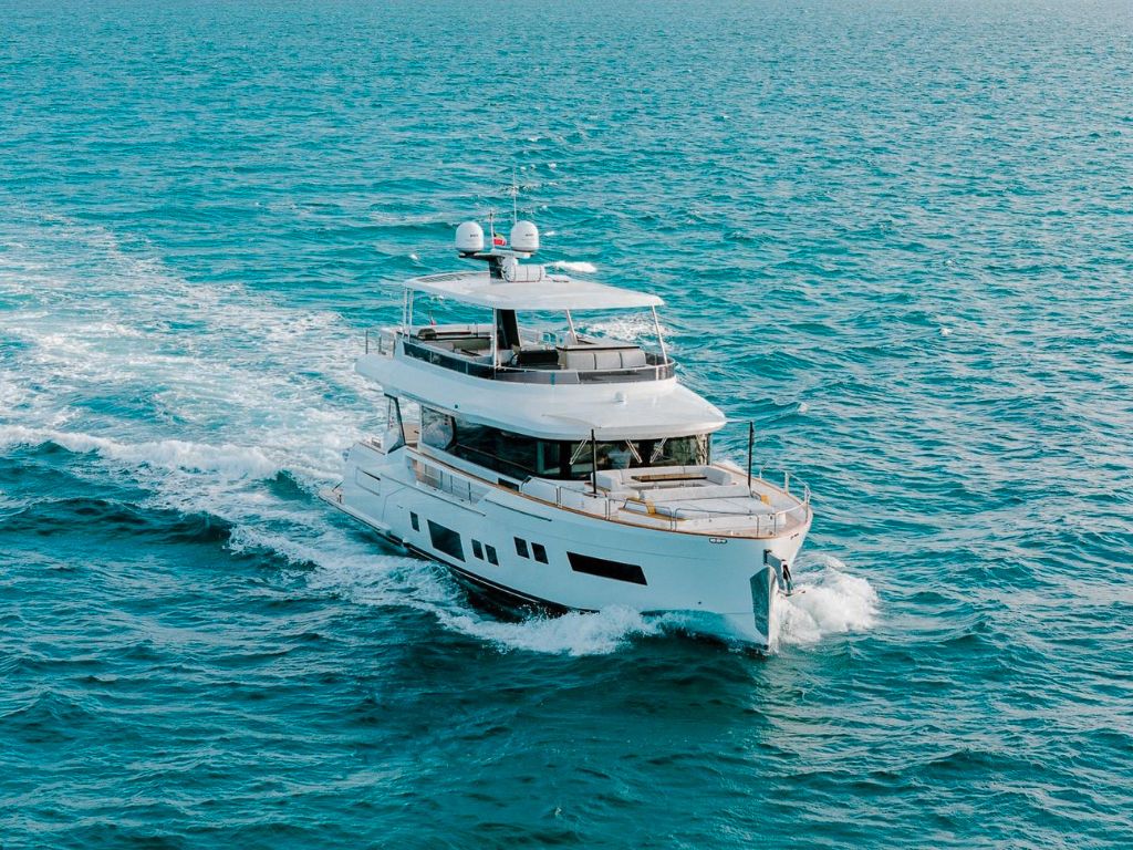 People swimming off the back of the 68 Sirena yacht in blue waters