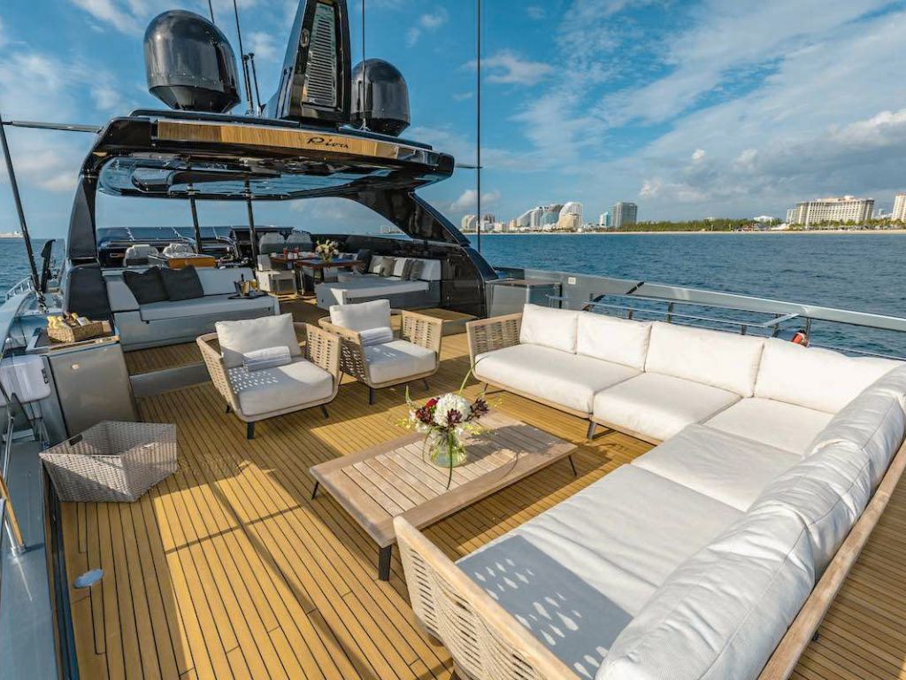 Guests relaxing on the foredeck sunpads of the 110 Riva yacht