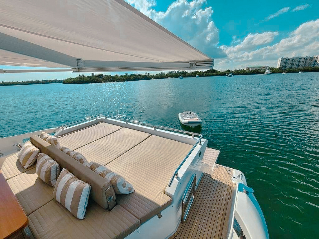 Guests relaxing on the bow sunpad of the 77 Azimut yacht