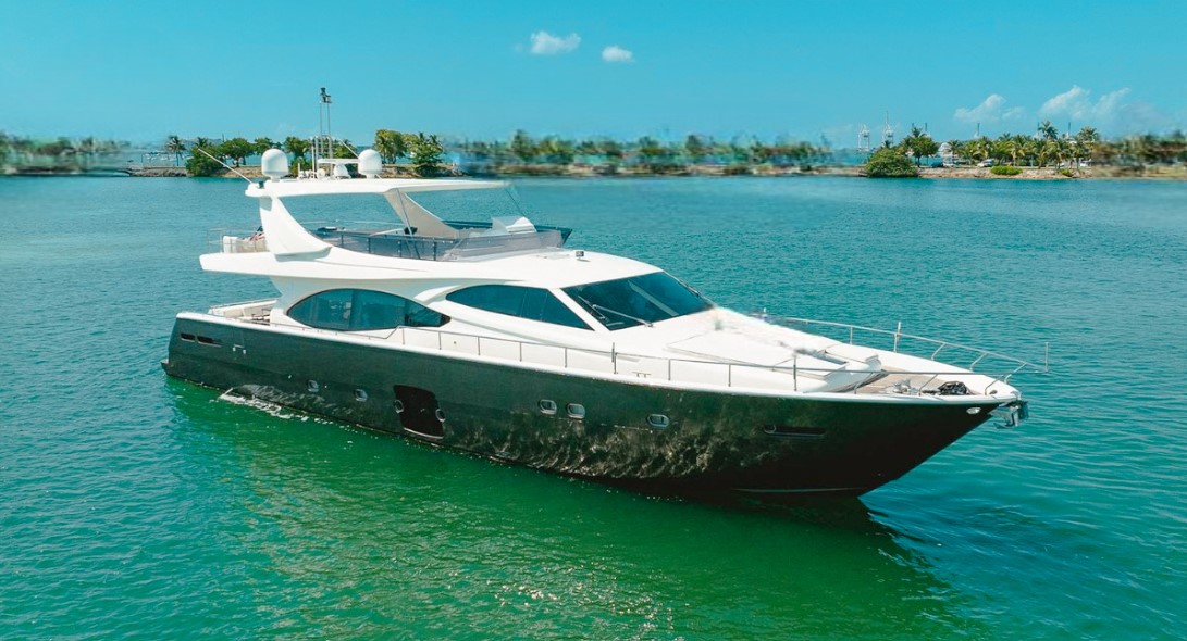 Luxurious 77ft Ferretti yacht sailing past the Miami skyline for a private charter.