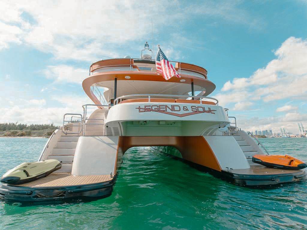 Spacious 62 Power Cat yacht cruising the waters of Miami on a sunny day