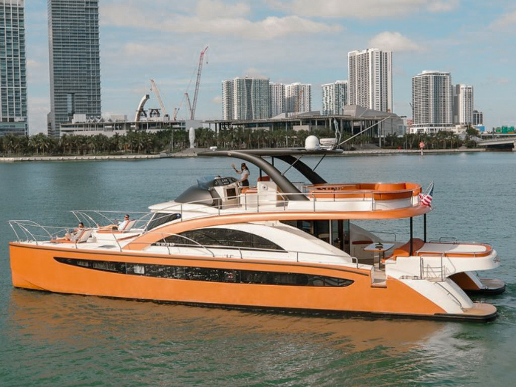 Guests relaxing on the bow of 62 Power Cat in Miami