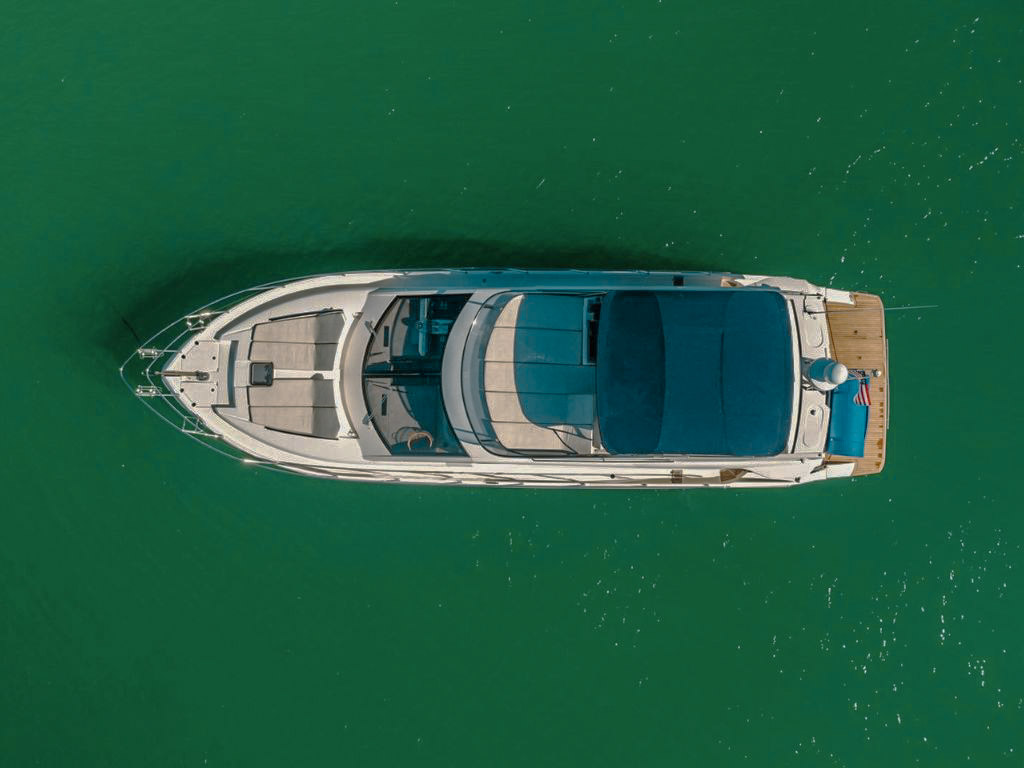 The 55 Absolute, a 55ft Prestige luxury yacht, sailing in Miami waters on a sunny day.