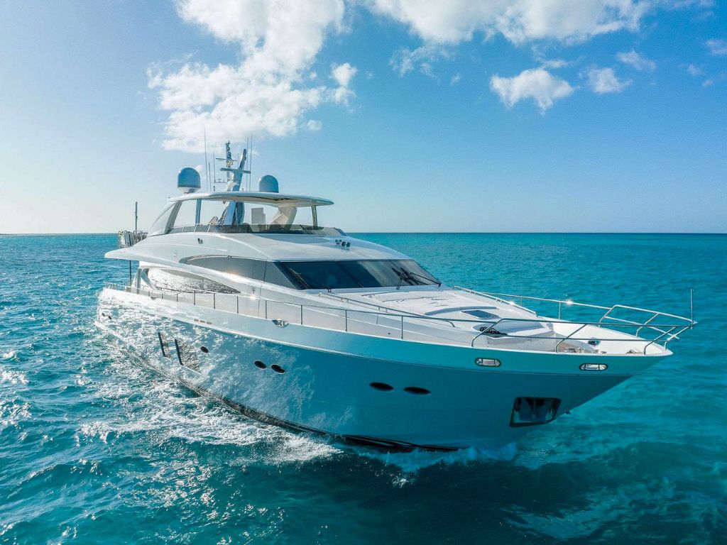 Luxury 95ft Princess Viking yacht cruising crystal-clear Bahamian waters near Nassau