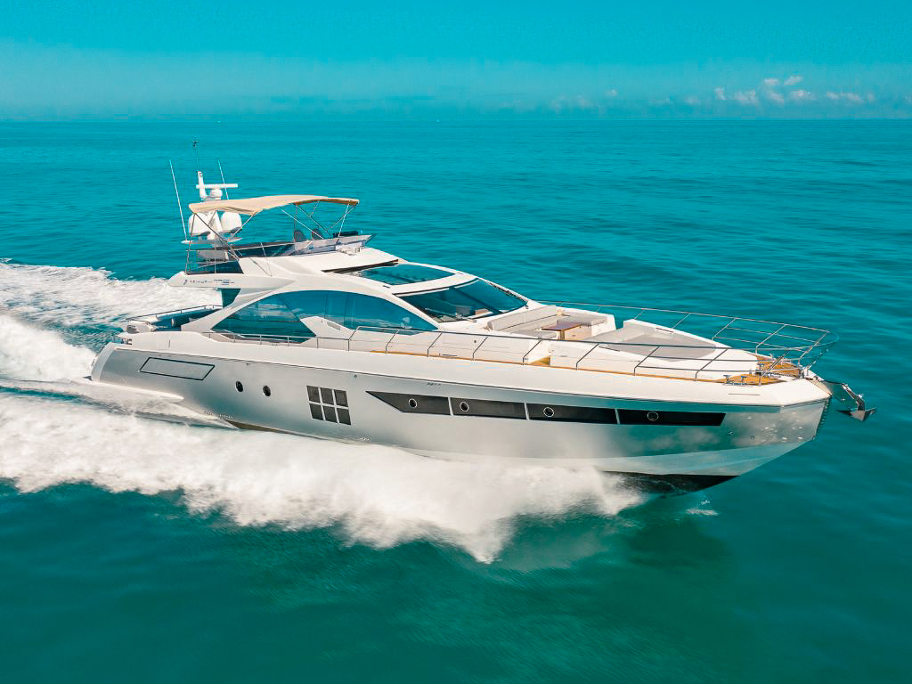 Luxurious 77ft Azimut S yacht cruising in Miami waters with guests enjoying the ride.