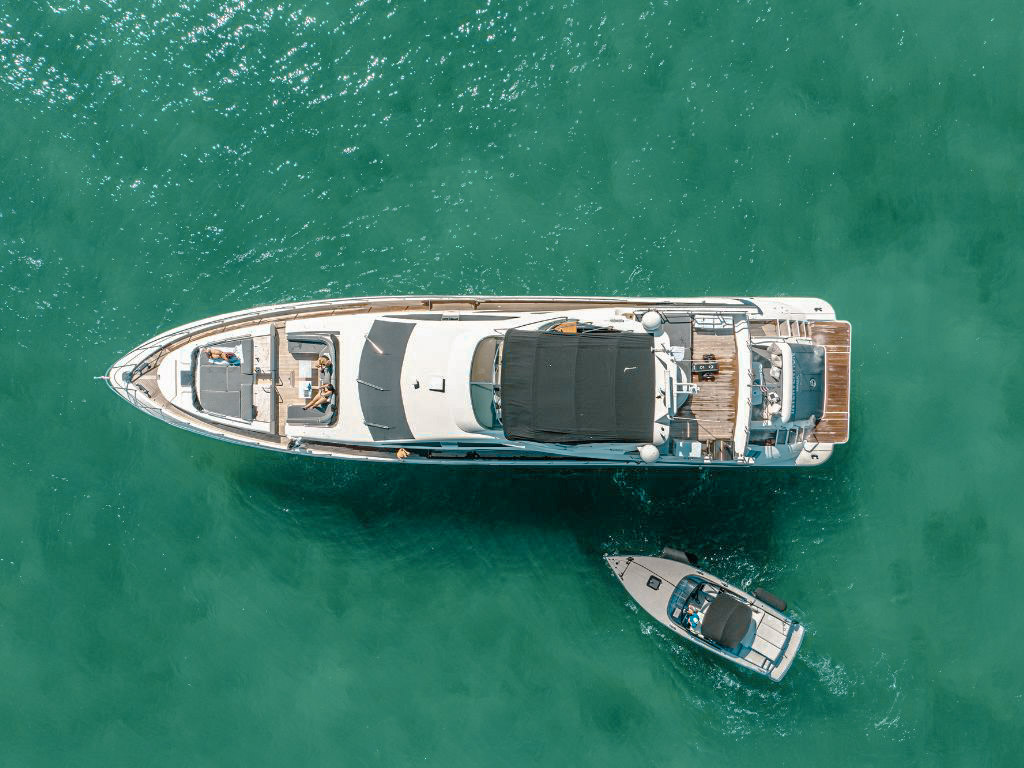 Guests relaxing on the sunpad at the front of the 100 Azimut yacht
