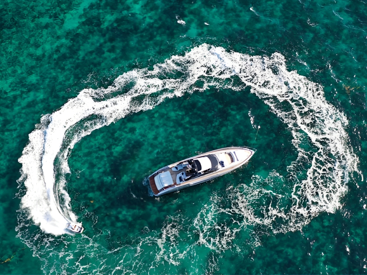 Side view of the 76 Riva II yacht cruising in blue waters