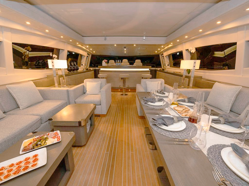 Guests relaxing on deck of the 109 Mangusta with ocean views