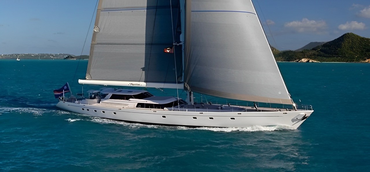 Stunning 155ft Royal Huisman yacht sailing crystal-clear Caribbean waters during a luxury charter.